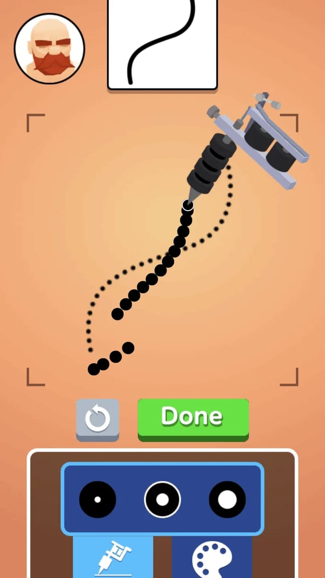 Tattoo shop gameplay showing a reference card with an S-curve design, the customer portrait, a coil tattoo machine laying a trail of black ink dots along a dotted guideline, with undo and Done buttons above a tray of ink cups