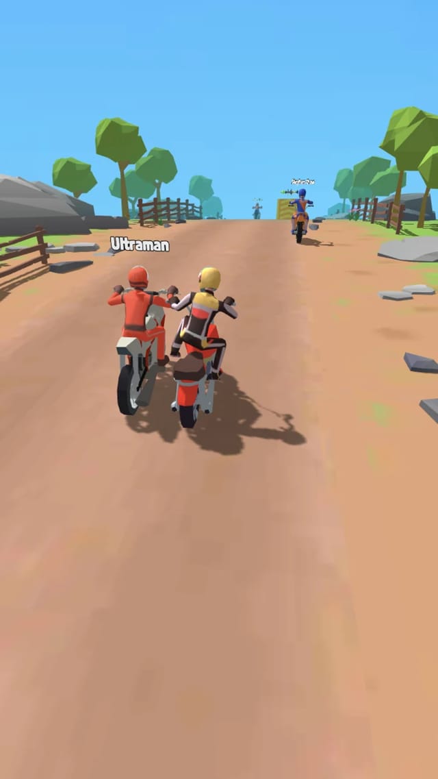 Moto Attack Bike Racing gameplay showing the player's motorcycle pulling alongside a rival rider named Ultraman on a dusty track, with more tagged riders ahead between fences and trees