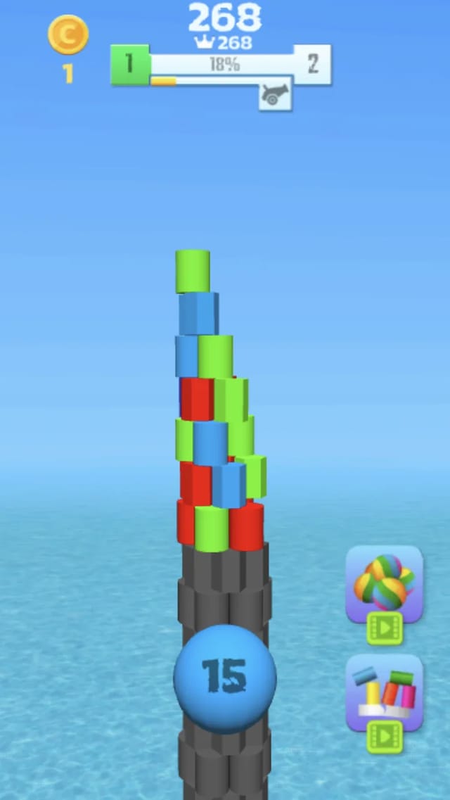 Tower Crash 3D gameplay showing a partially collapsed colorful block tower over the water, the next blue ball displaying 15 remaining shots, a score of 268 with a best-score crown, a coin counter and a level 1 to 2 progress bar at 18 percent