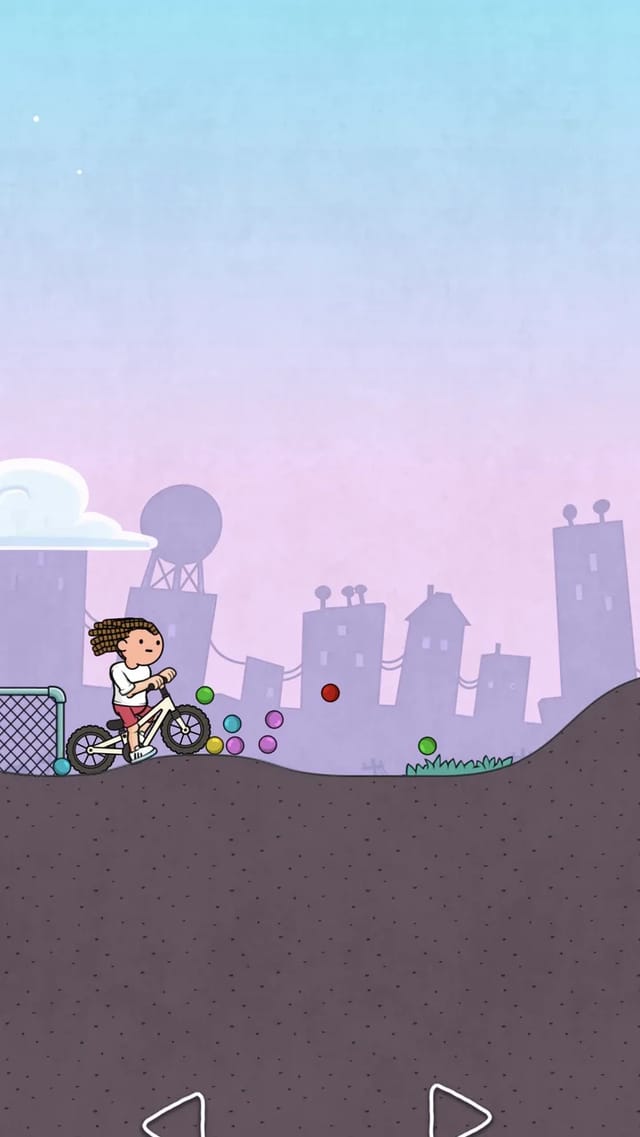 Wheel Master Bike cyclist riding past scattered colored balls toward a rising hill